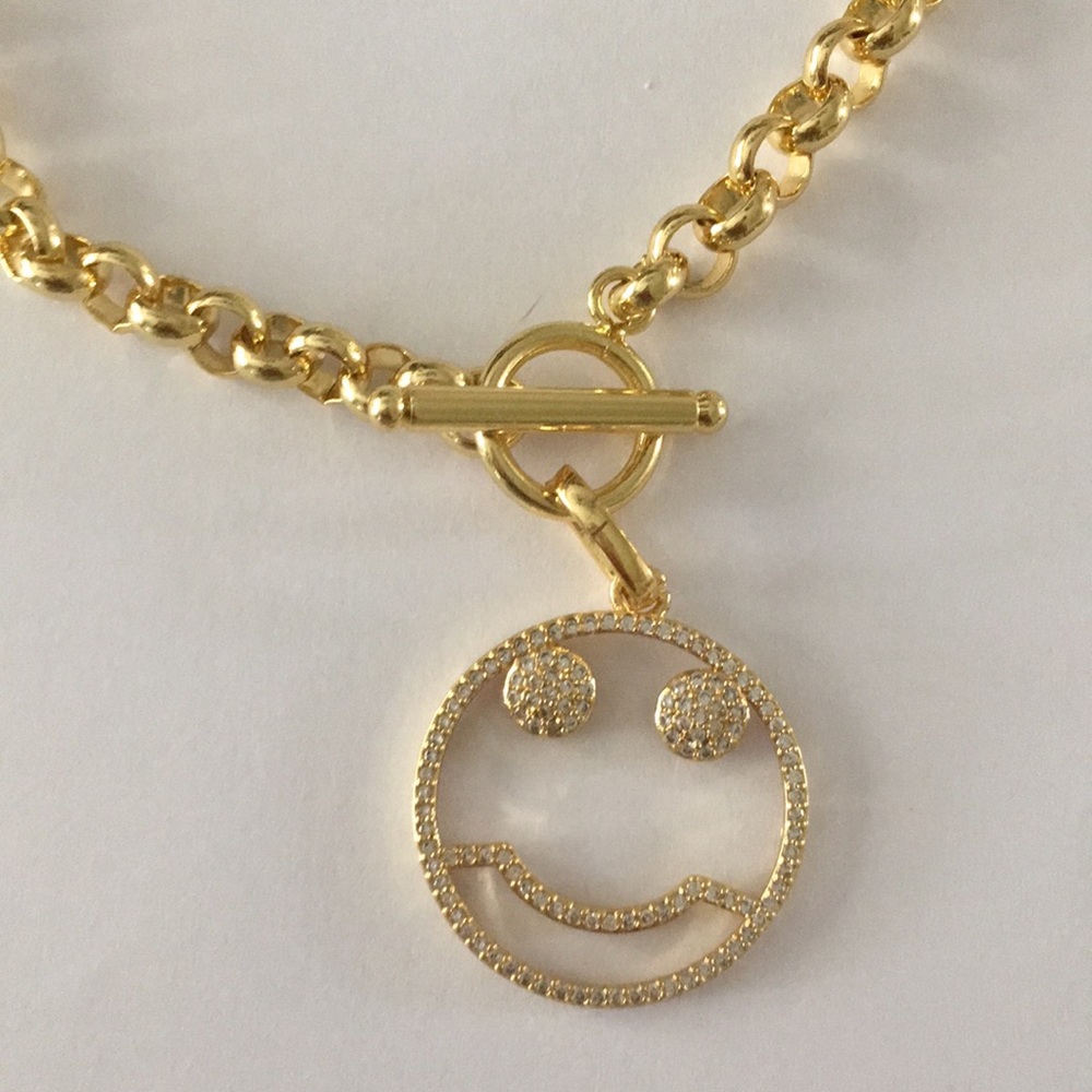 Gold rolo chain with CZ smiley face charm.